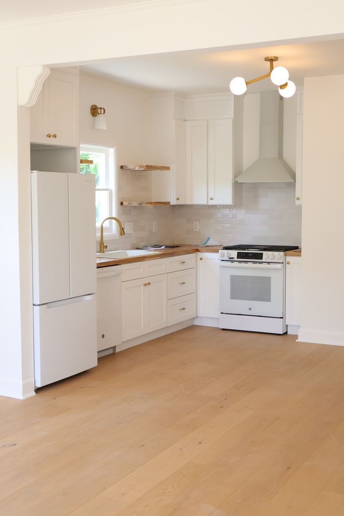 Remodeled kitchen with butcher block counters and brass hardware